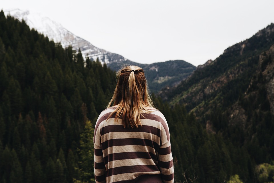 person staring at a mountain landscape