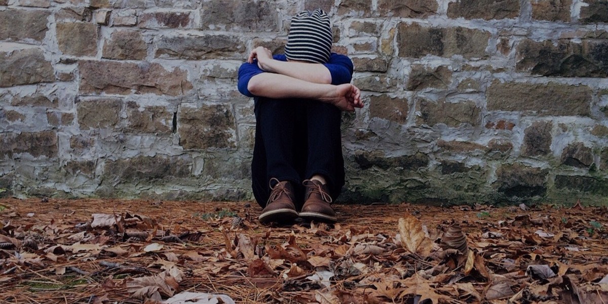 person sitting with head down