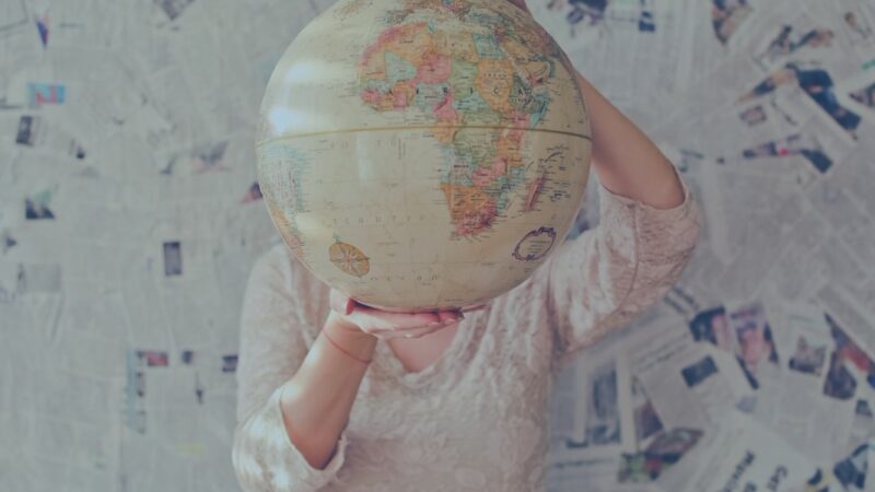 person holding a globe