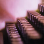 Close-up of vintage typewriter keys in soft focus, highlighting retro technology and design.