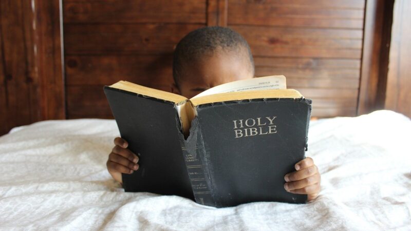 Child reading Bible