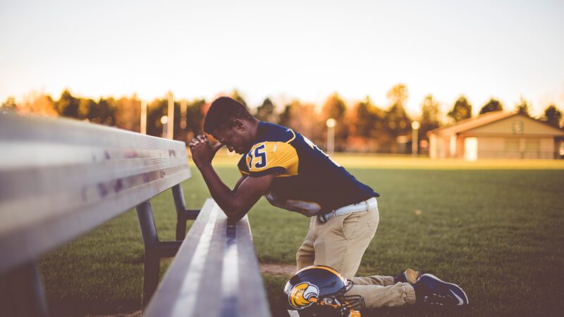 football player praying