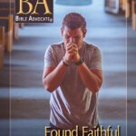 Man praying in a church aisle, cover of Bible Advocate magazine, January-February 2021 issue titled Found Faithful.