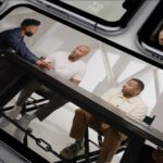 Group discussion at a table displayed on multiple smartphones, showcasing digital content streaming.