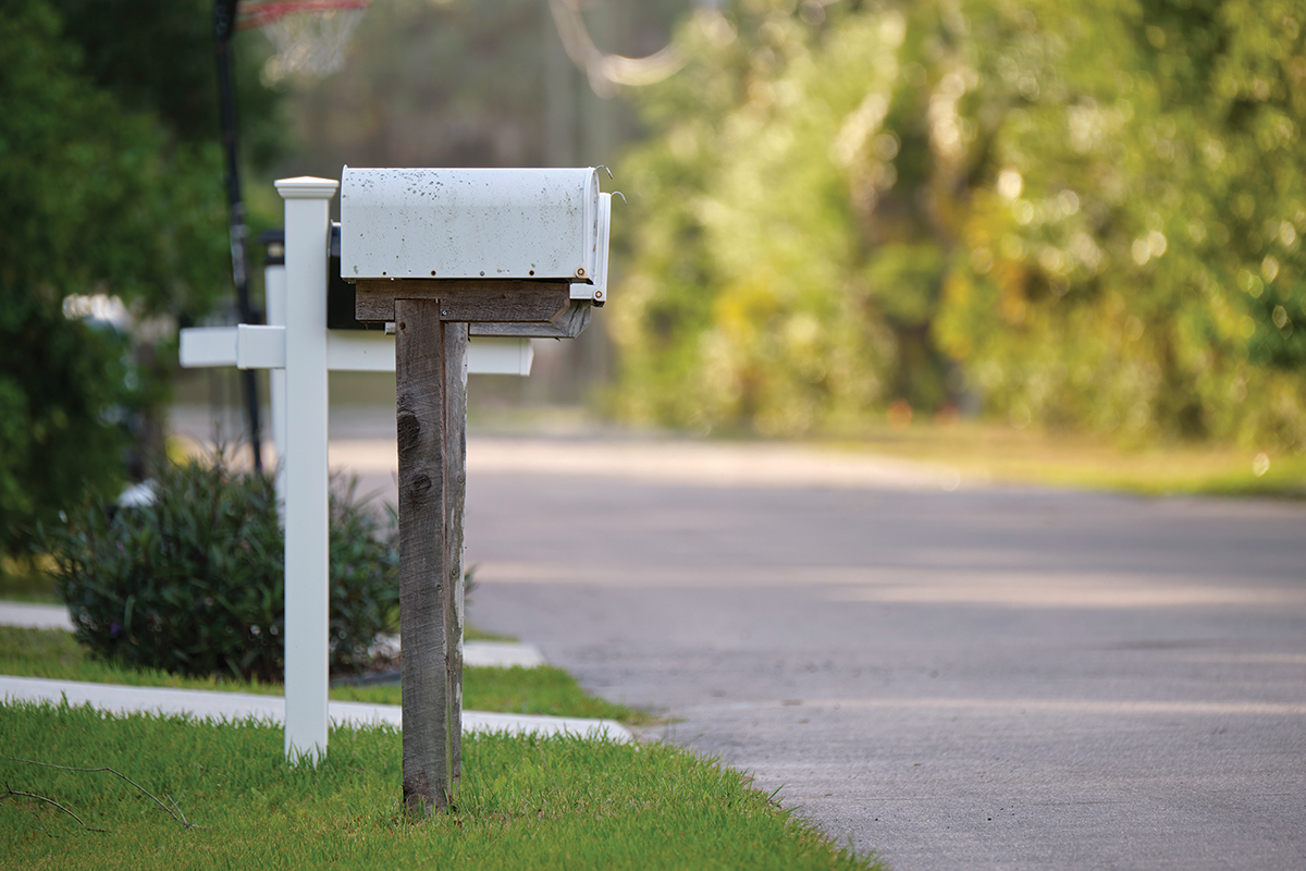 Typical american outdoors mail box on suburban street side.